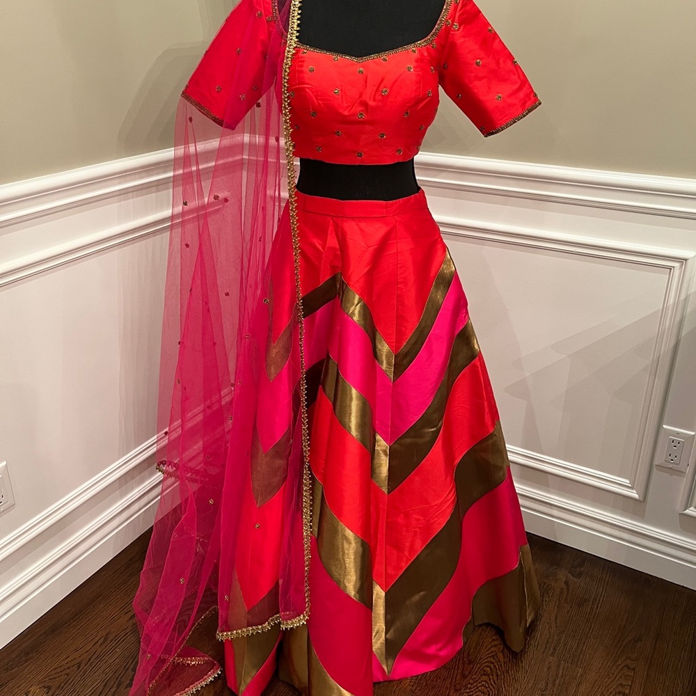 Custom made designer lengha. Gorgeous chevron print red, pink & gold outfit.